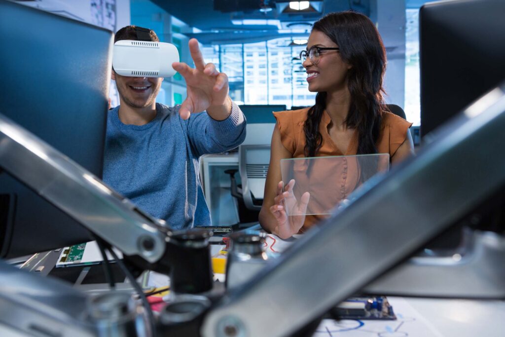 Executives using virtual reality headset at desk in office